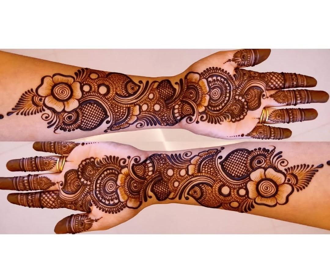 A detailed Arabic Mehndi design featuring bold lines and floral patterns